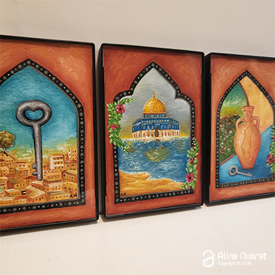 3 framed acrylic paintings in an angle view.